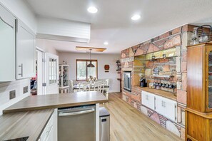 Enjoy family meals in this kitchen with a dishwasher, oven, and wine rack.