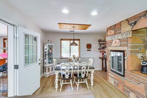 Enjoy meals in this cozy dining area with a traditional table and comfortable chairs, a fireplace, and a TV.