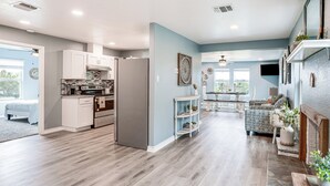 A spacious living area with a kitchen, a dining area, and a seating area with a fireplace. - Brownwood Family Home - 2 Mi to Public Marina! (Brownwood)