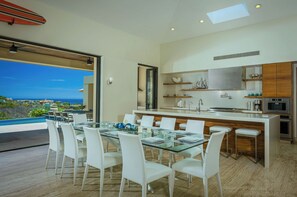 Prepare meals in the spacious kitchen with a large island, sink, and ample counter space.