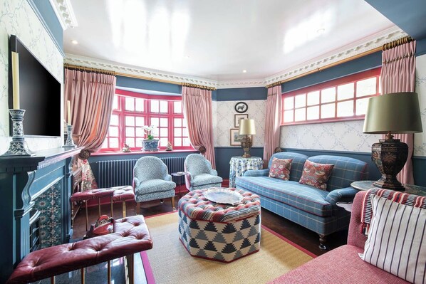 Relax in style with a plush sofa, matching armchair, and tasteful wall art in this elegant sitting room.