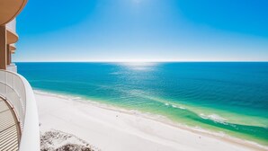 A beach view with clear turquoise water and a bright sun. - Phoenix Gulf Towers 2605 4 Bedroom Condo (Orange Beach)