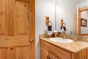 A wooden door, a granite countertop sink, and a mirror in a bathroom. - Timber Wolf Lodge 10d 2 Bedroom Condo by RedAwning (Park City)