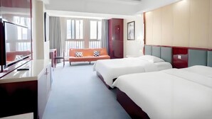 A hotel room with two beds, a sofa, a TV, and a desk. - Memory Hotel (Zhenjiang)