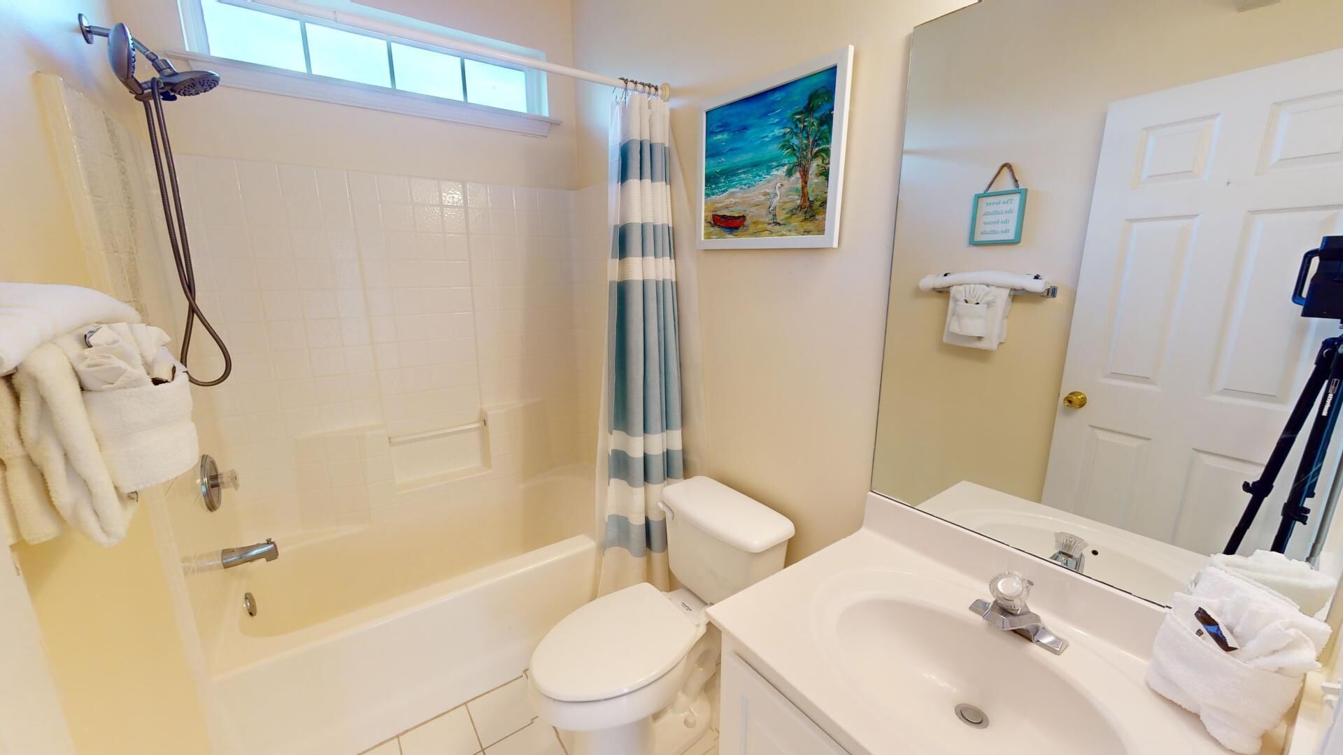 A bathroom with a shower, toilet, and sink.