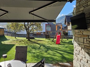 Relax in a family-friendly outdoor space with a covered seating area and a playground nearby.