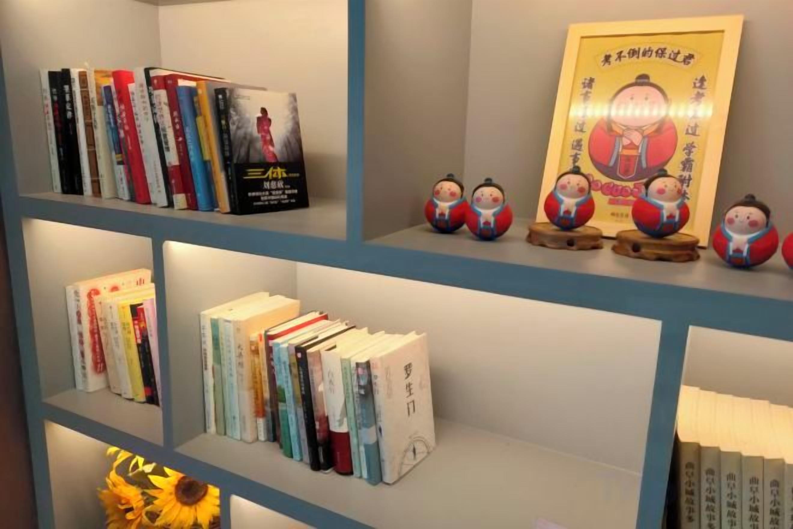 A bookshelf with books and decorative items.