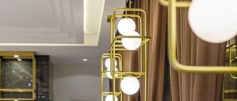 Un candelabro con múltiples bombillas esféricas y un marco dorado.