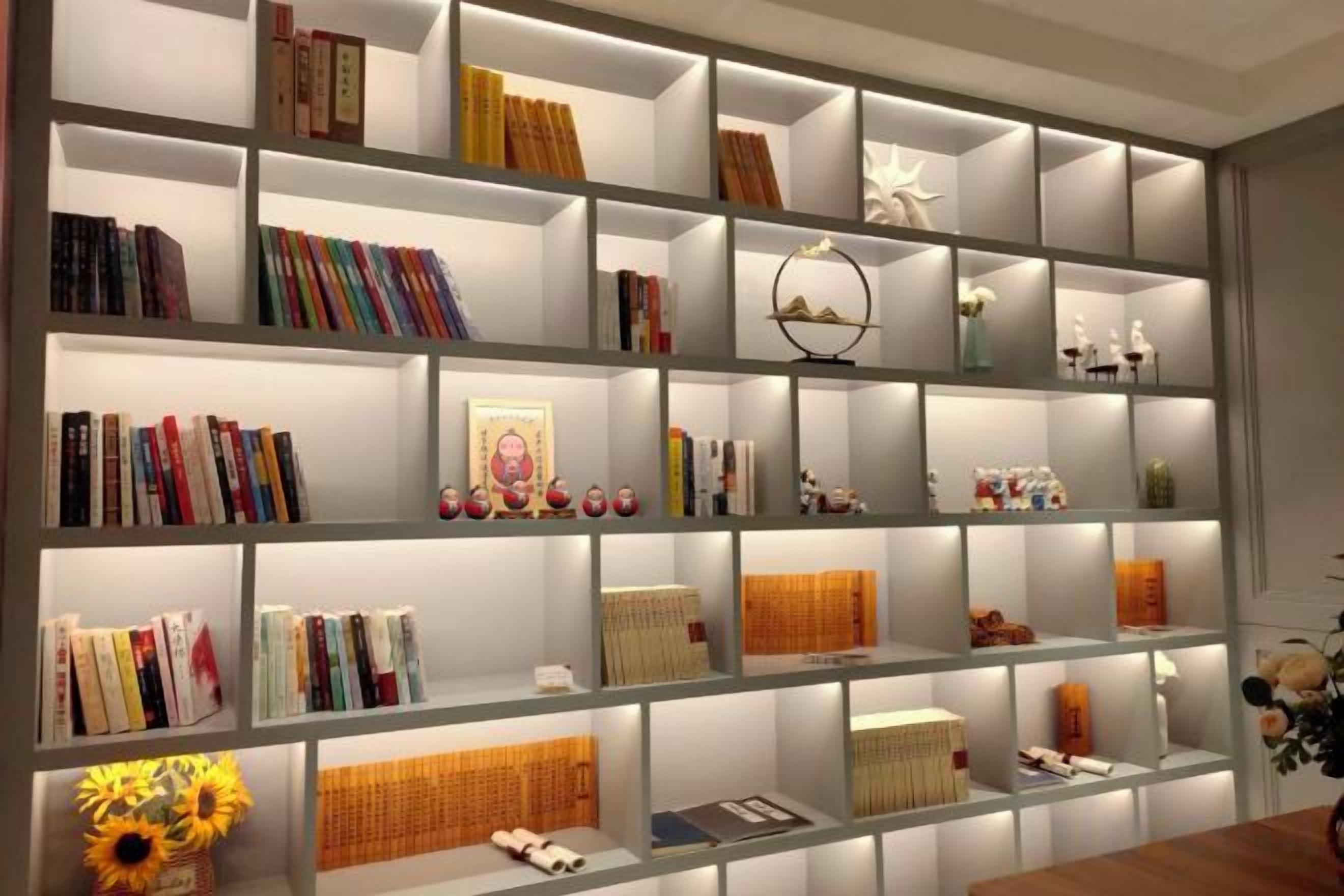 A bookshelf with various books and decorative items.