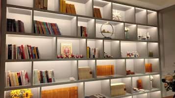 A bookshelf with various books and decorative items.