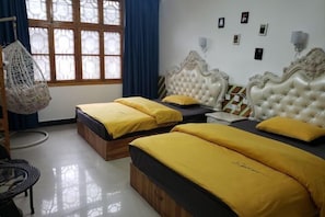 A room with two beds, a hanging chair, and a window with blue curtains. - Xiangyunge Inn (Fenghuang County)