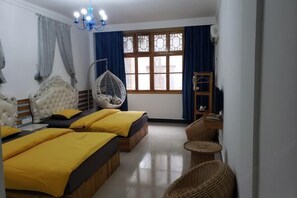 A hotel room with three beds, a hanging chair, a wooden ladder, and a large window with curtains. - Xiangyunge Inn (Fenghuang County)