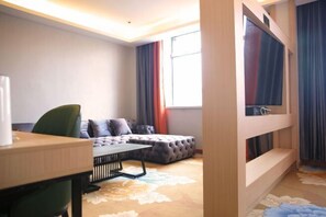 A modern hotel room with a sofa, a small table, a window with curtains, and a bunk bed. - Mingyangxuan Fashion Hotel (Tianjin Tucheng Subway Station) (Tianjin)