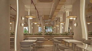 A modern restaurant interior with white furniture, pendant lighting, and a herringbone wood floor. - Eco Nest Hotel & Apartment (Hanoi)