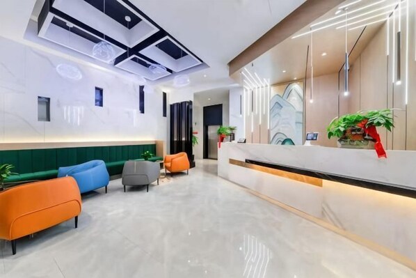 A modern hotel lobby with a reception desk, seating area, and a ceiling with geometric light fixtures. - BoYue Hotel (Yiwu International Trade City) (Yiwu)