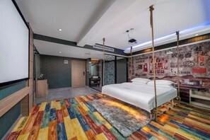 A modern hotel room with a bed, a colorful striped carpet, a large mirror, and a wall with motivational posters. - Guangzhou Baisi Elegant Hotel (Huadu Shiling) (Guangzhou)