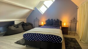 A bedroom with a bed, two nightstands, a skylight, and a view of the sky. - Heavenly vacation home near the sea (Bruinisse)