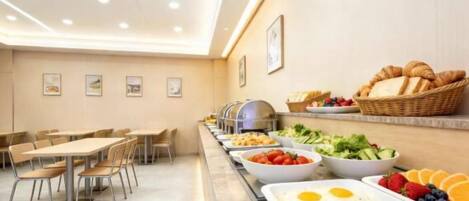 A buffet setup with various food items and seating arrangements.