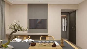 Enjoy a serene dining experience in this stylish space, featuring a long table, elegant artwork, and a touch of nature.