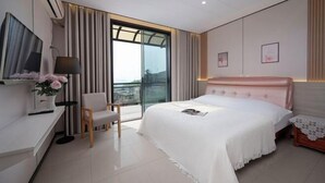 A modern bedroom with a large bed, a desk, a chair, and a balcony view. - Wugong Mountain near Shuiya Residence (Luxi)
