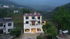 A two-story building with a flat roof and a balcony on the second floor. - Wugong Mountain near Shuiya Residence (Luxi)