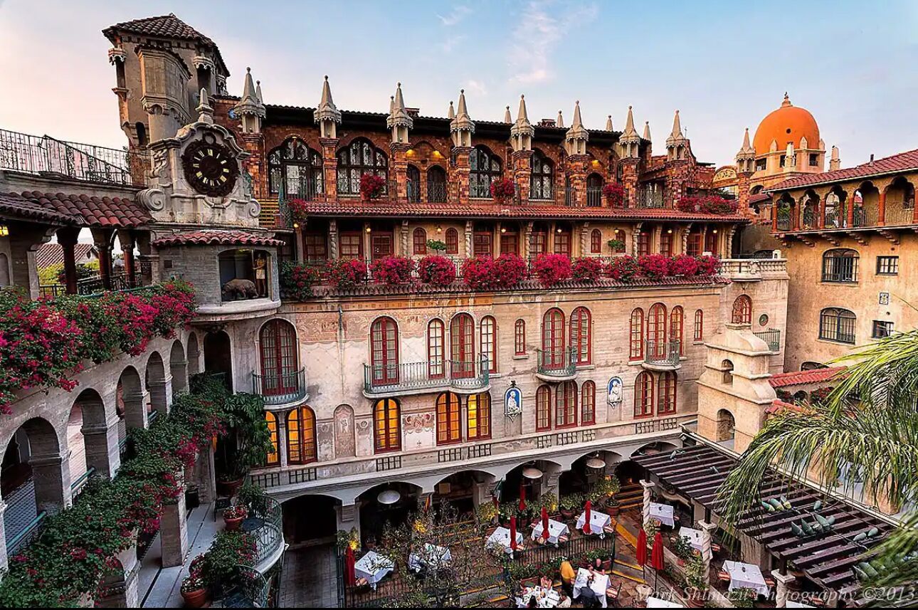 A historic building with multiple balconies, arches, and a clock tower.