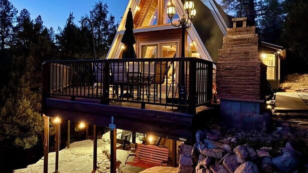 A cabin with a balcony, stone foundation, and a chimney. - A-Frame On The Rocks. Hot Tub. Payson. Waterwheel. (Payson)