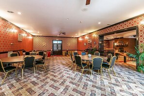 A conference room with patterned walls, a patterned carpet, and multiple tables and chairs. - Kentucky's Majestic Mountaintop Estate with pool: The Bluegrass Palace (Langley)