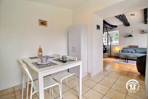 Enjoy a cozy combined living and dining space with a kitchenette, perfect for a relaxing stay.