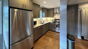 A modern kitchen with stainless steel appliances, wooden flooring, and a central island. - Fantastic mountain village condo in Steamboat Springs! Minutes to ski area base! (Steamboat Springs)