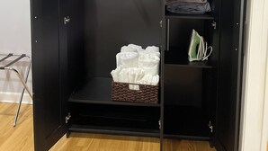 A black wardrobe with multiple shelves, a hanging rack, and a basket. - Charming 2-bedroom 1 bath, Livingroom, full kitchen, WiFi & AC in Alpharetta.  (Alpharetta)