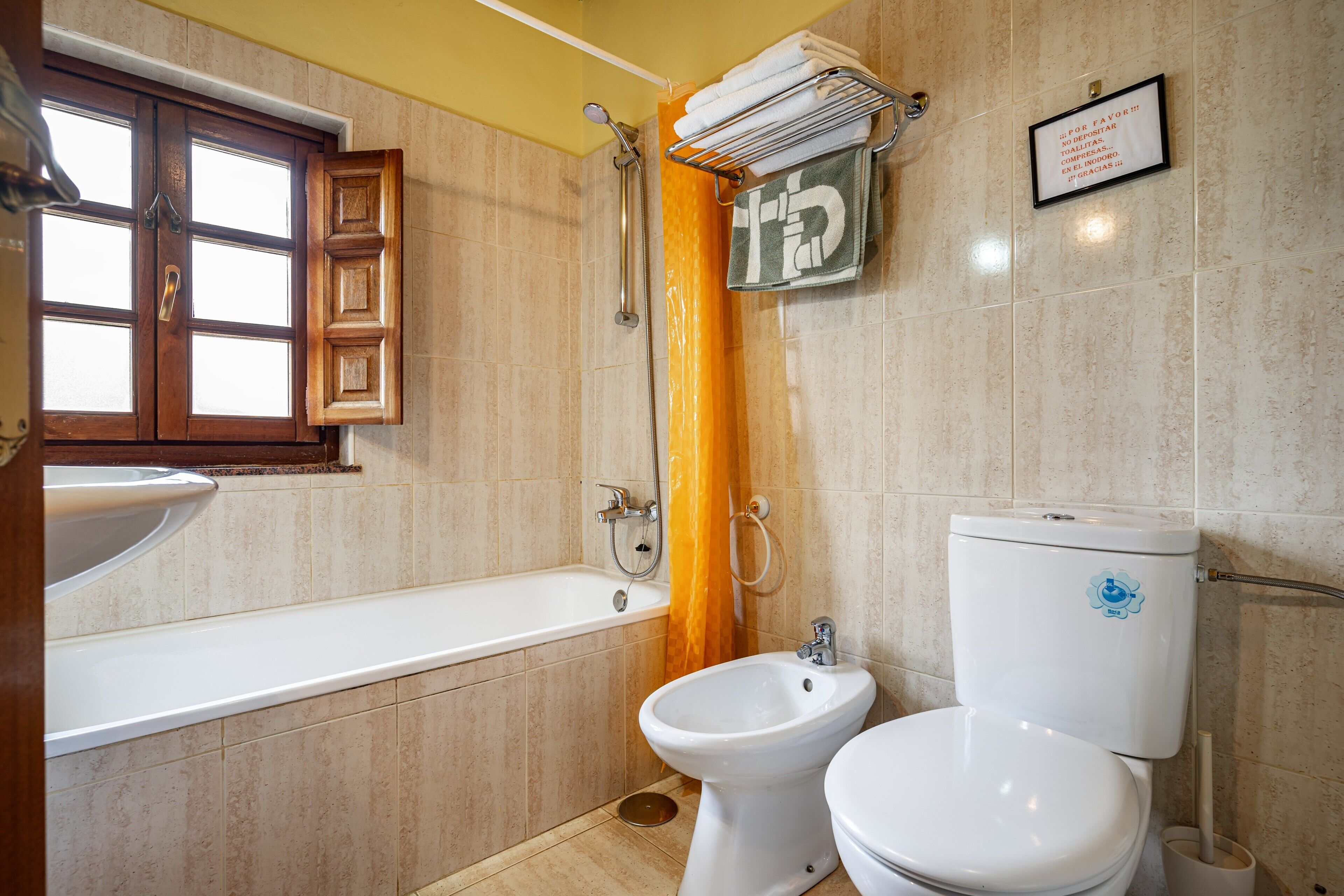 A bathroom with a bathtub, a bidet, and a toilet.
