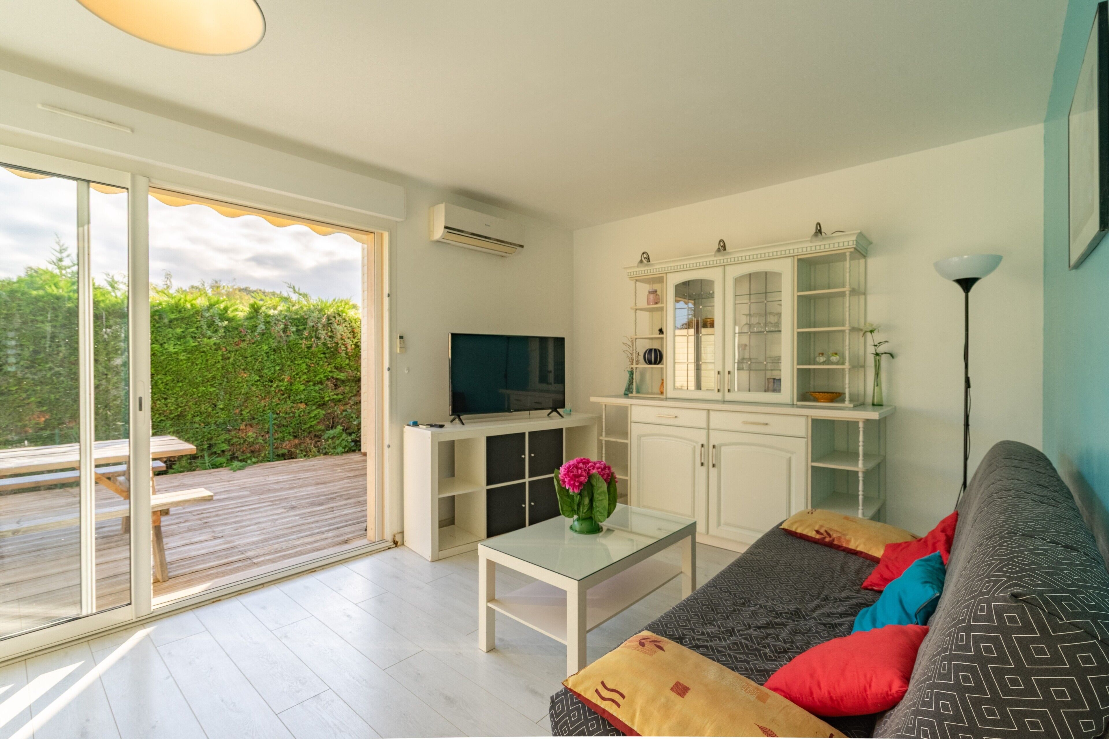 A modern living room with a sofa, a coffee table, a TV, and a cabinet.