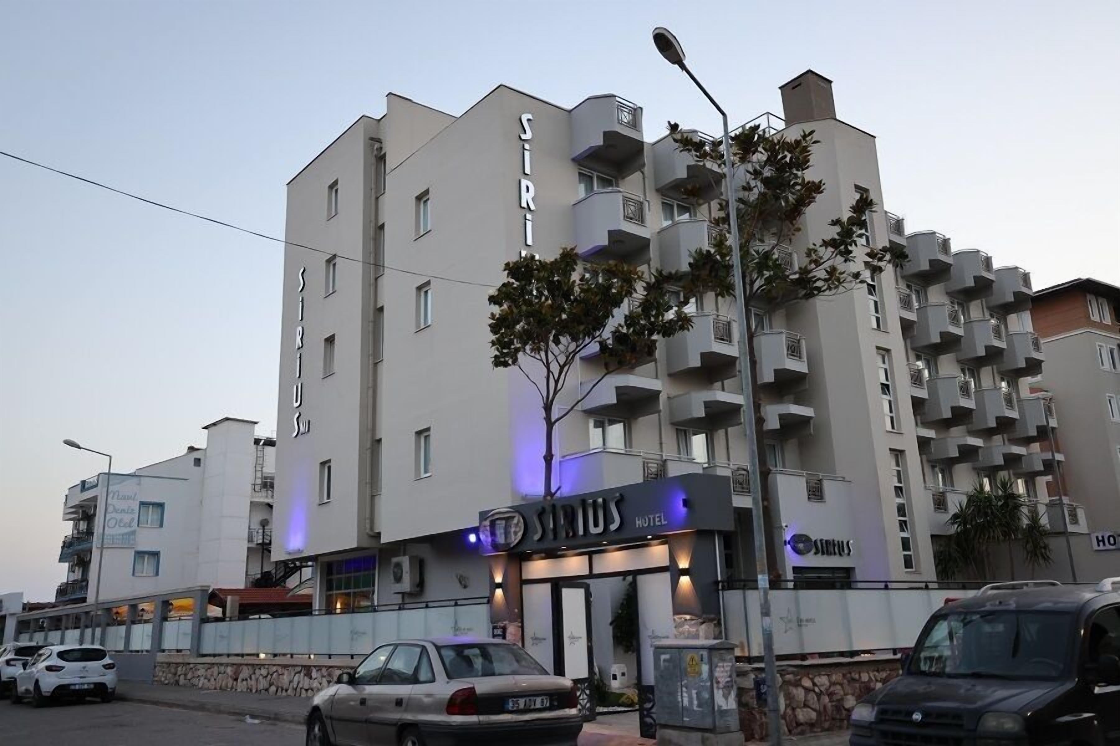 A hotel named 'Sirius Hotel' with a modern architectural design, featuring balconies and a visible entrance.