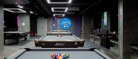 A billiards room with a pool table, a billiard cue rack, and a sign for the Billiards Club.