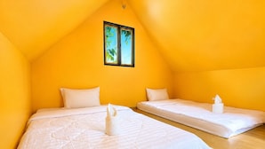 A room with two beds, a window, and a wooden floor. - Plankton Bungalow and Camping (Koh Rong)