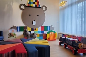 A child's playroom with colorful furniture, a bear-shaped wall decoration, and a toy train. - Blocks Forest (Taitung)