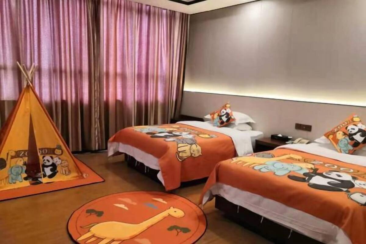 A hotel room with two beds, a tent decoration, and a large window with curtains.