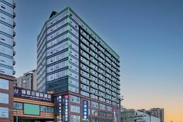 A multi-story hotel with a modern design, featuring a prominent signage for the hotel and its amenities. - Eiffel International Hotel (Chengdu Hongpailou Metro Station) (Chengdu)