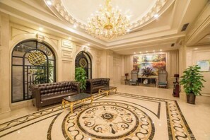 A luxurious lobby with a grand chandelier, a central seating area, and a decorative floor pattern. - Eiffel International Hotel (Chengdu Hongpailou Metro Station) (Chengdu)