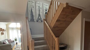 A staircase with wooden railings leading to an upper floor. - Mull Tranquility Retreat (Isle of Mull)
