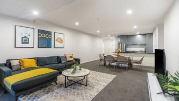 Apartment, 3 Bedrooms | Living area | 55-inch LED TV with cable channels