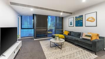 Apartment, 3 Bedrooms | Living area | 55-inch LED TV with cable channels