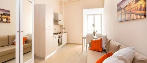 A modern apartment with a living room, kitchen, and dining area.