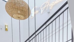 A modern interior with a staircase, a woven light fixture, and a neon sign reading "Gi Gi Augustin". - Refined Studio Historic Center Alicante (Alicante)