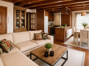 A cozy living room with a sofa, coffee table, and a dining area with chairs. - BAQUEIRA URBANIZAC RUDA BLANHIBLAR APARTMENT FOR UP TO 7 PEOPLE (Baqueira)