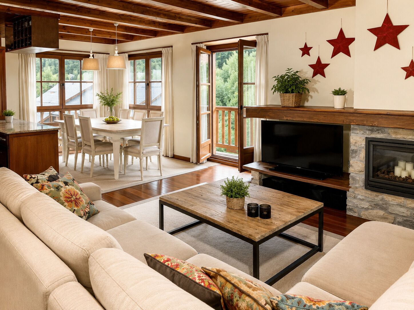 A cozy living room with a fireplace, a television, and a dining area with a table and chairs.