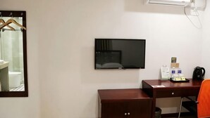 A hotel room with a desk, a chair, a television, and a mirror. - Shell Hotel (Shanghai Zhang Yan Song Jin Street) (Shanghai)