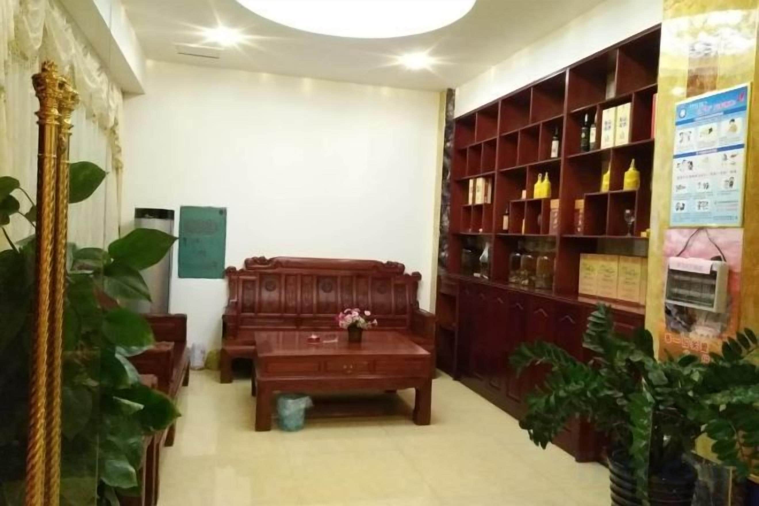 Una stanza con un divano, un tavolino da caffè e una libreria piena di libri e oggetti decorativi.