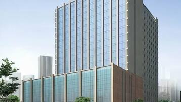 A modern high-rise building with a glass facade and a flat roof.